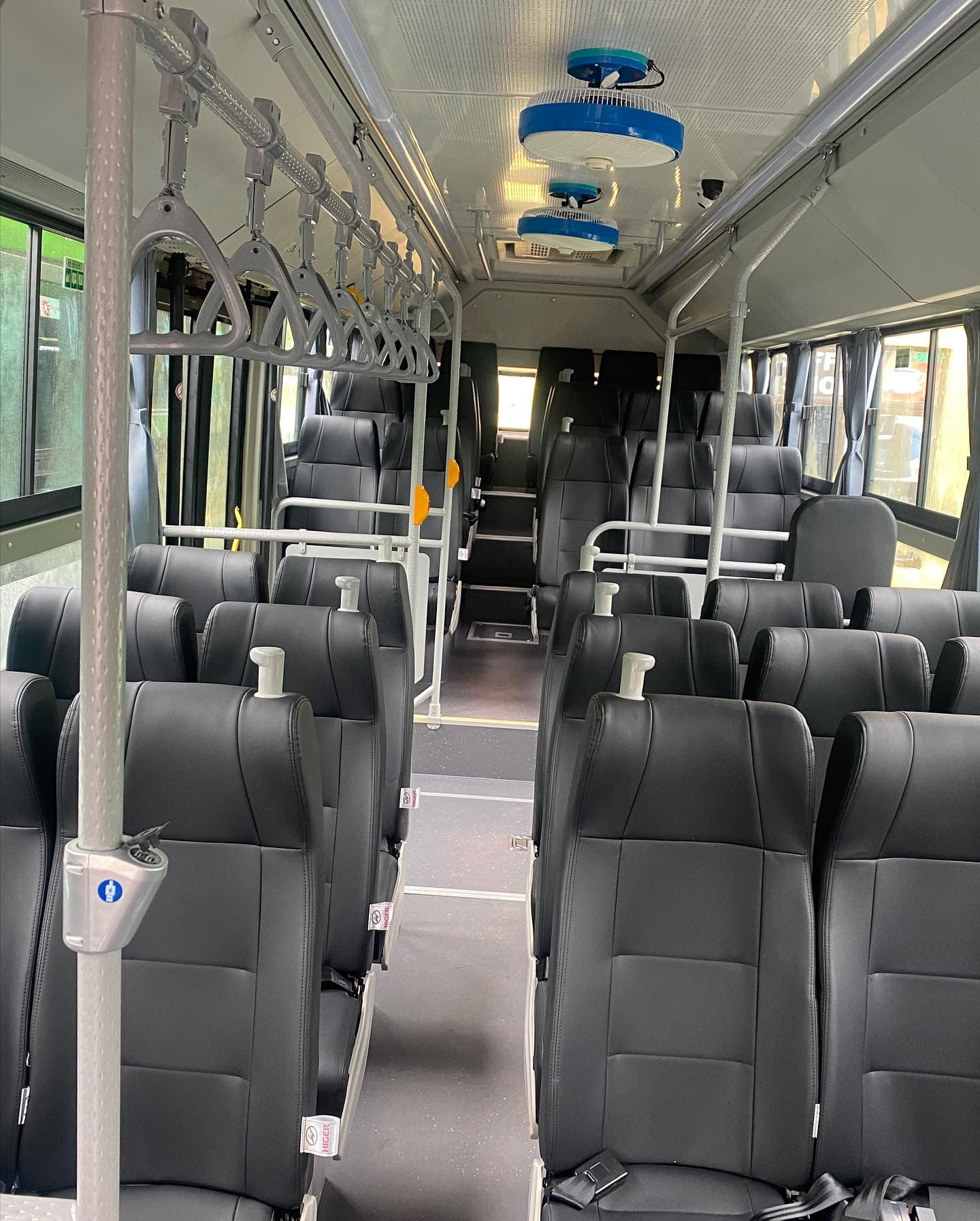 Rows of leather seats inside a Volcano Express Higer coach